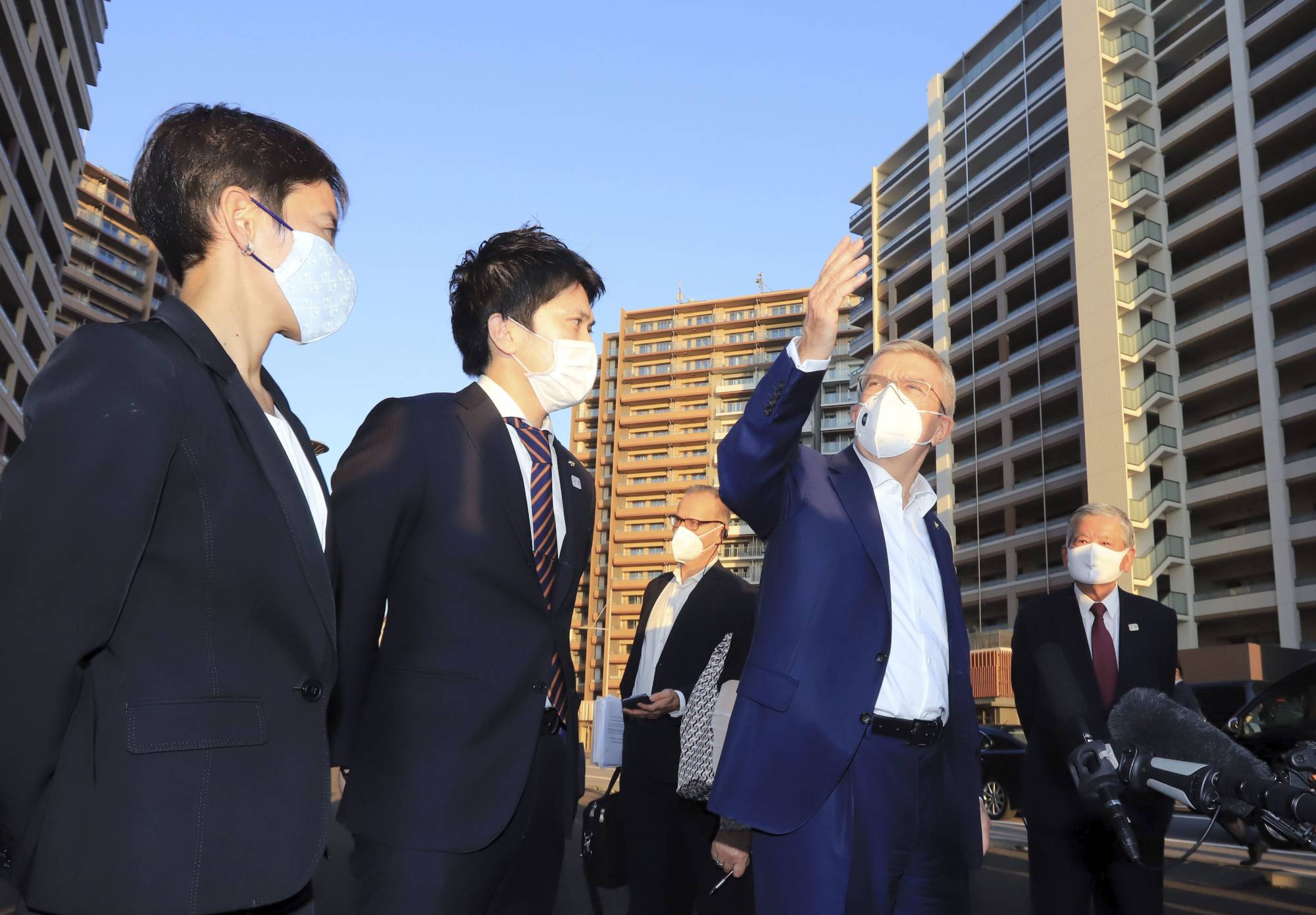 Saburo Kawabuchi (right), mayor of the Olympic village, accompanies IOC chairman Thomas Bach (center) during his visit to the Olympic village in Tokyo's Chuo Ward in November. | KYODO